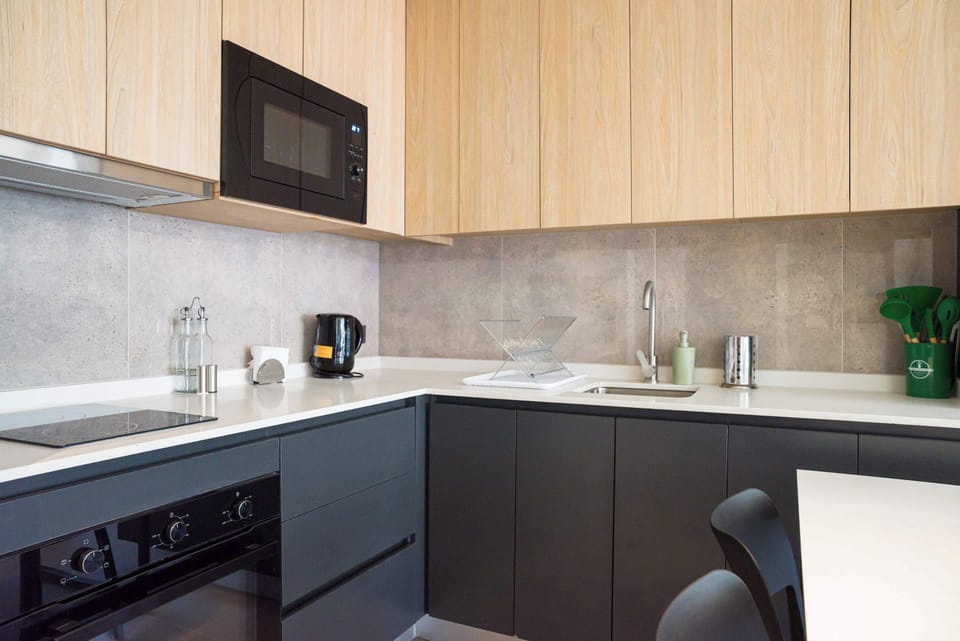 Sleek and modern kitchen with all essentials for a comfortable stay, perfect for cooking your favorite meals.