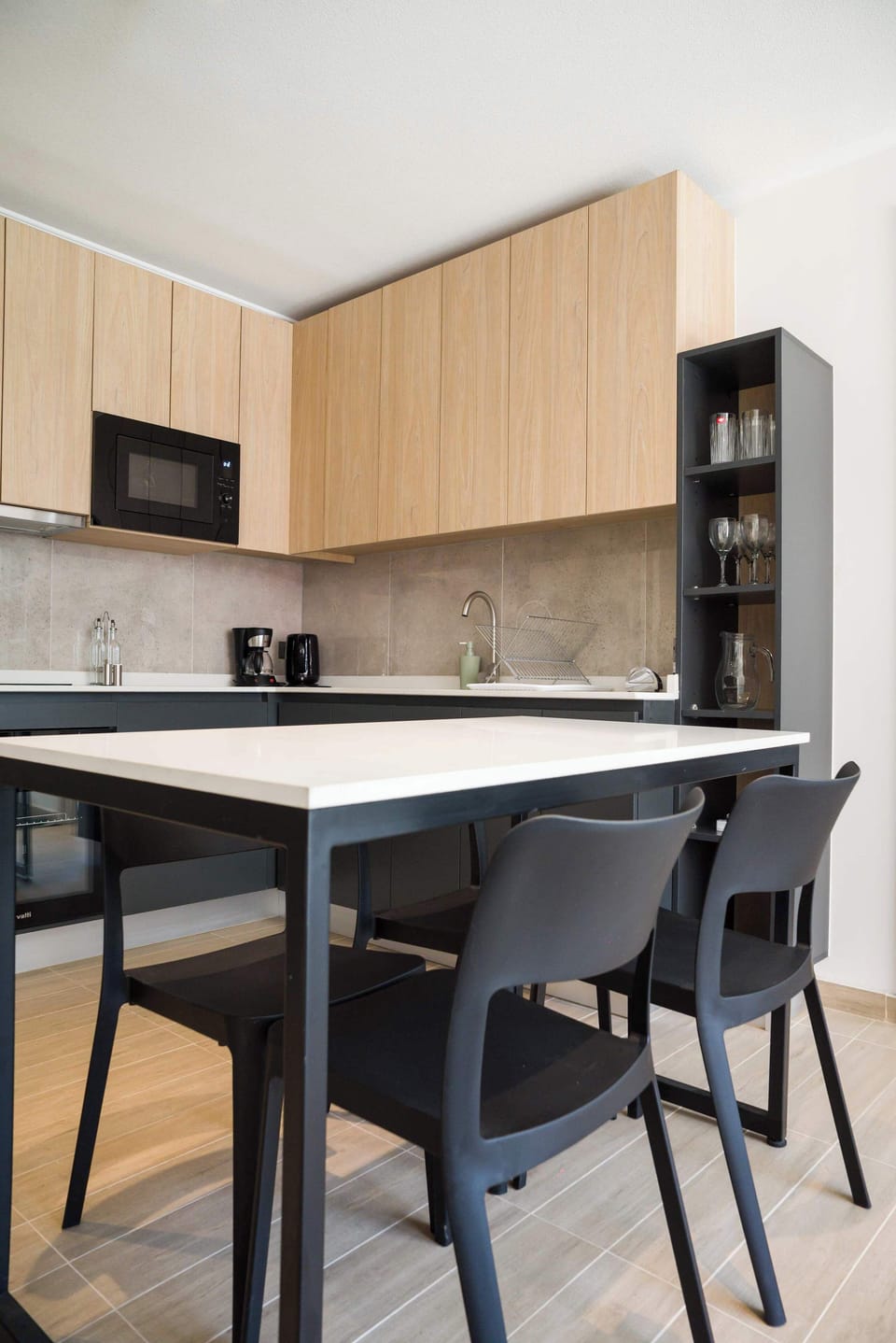 Sleek and modern kitchen with ample seating, perfect for enjoying meals and coffee breaks.