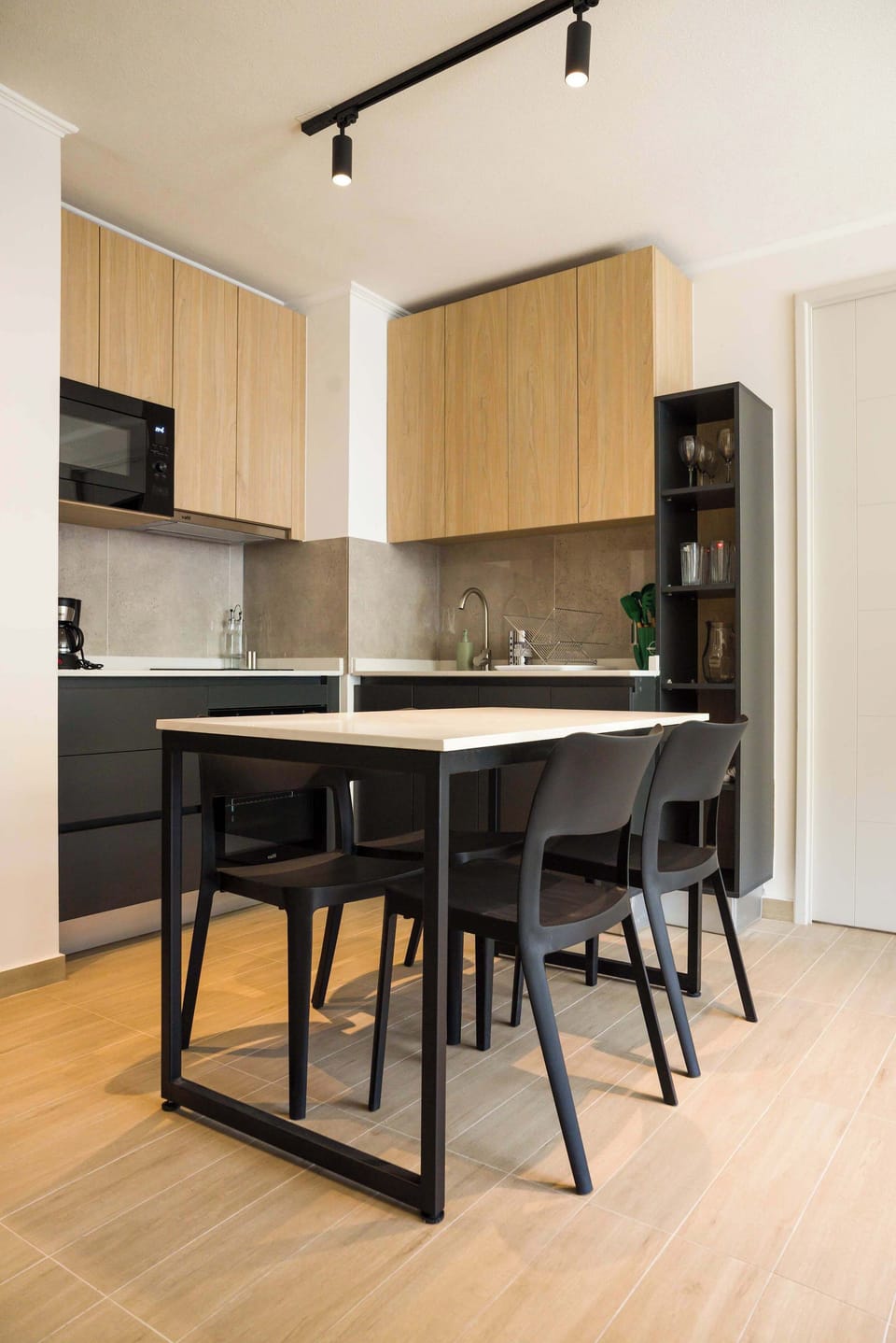 Sleek and modern kitchen with stylish dining area, perfect for cozy meals.