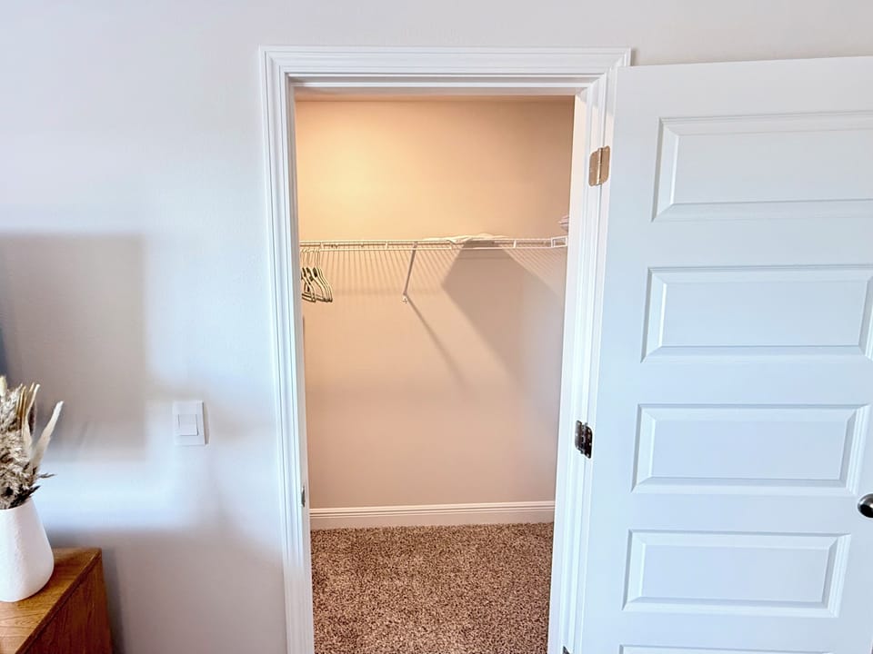 Primary bedroom walk-in closet