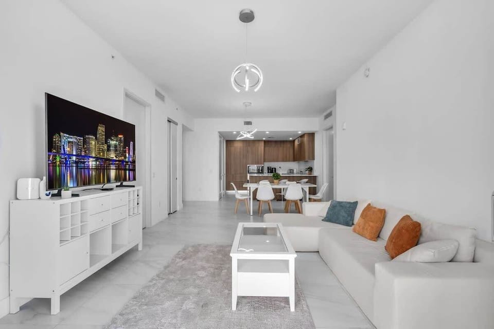 Designed for Gathering! This wide view shows the seamless flow between the living room, dining area, and kitchen. Whether you're watching the big screen or grabbing a snack, everyone stays connected in this modern, airy space.