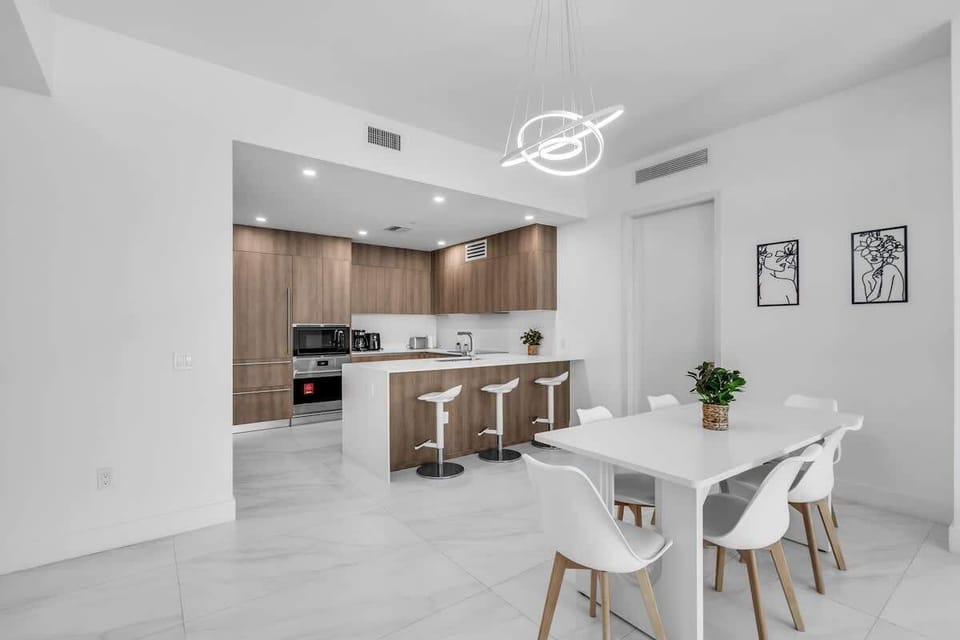 Elegant & Spacious Dining! Gather for memorable meals at this modern dining table that comfortably seats six. With additional seating at the kitchen island, there is plenty of room for the whole group to enjoy breakfast or dinner together.