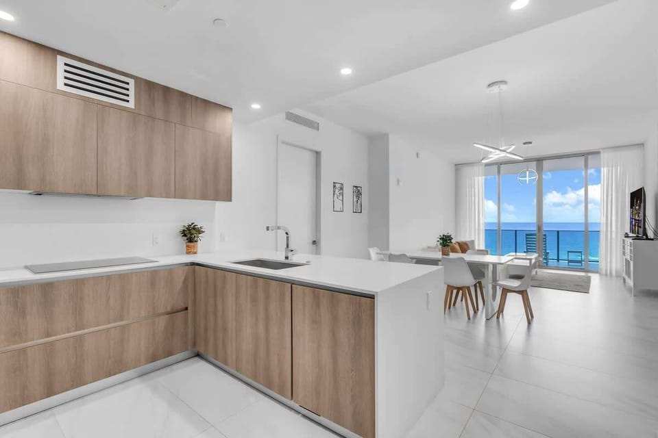 Gourmet Chef's Kitchen! Prepare meals in style with top-of-the-line Wolf and Sub-Zero appliances. The large island and open layout make it easy to socialize with family while enjoying the ocean view from the kitchen