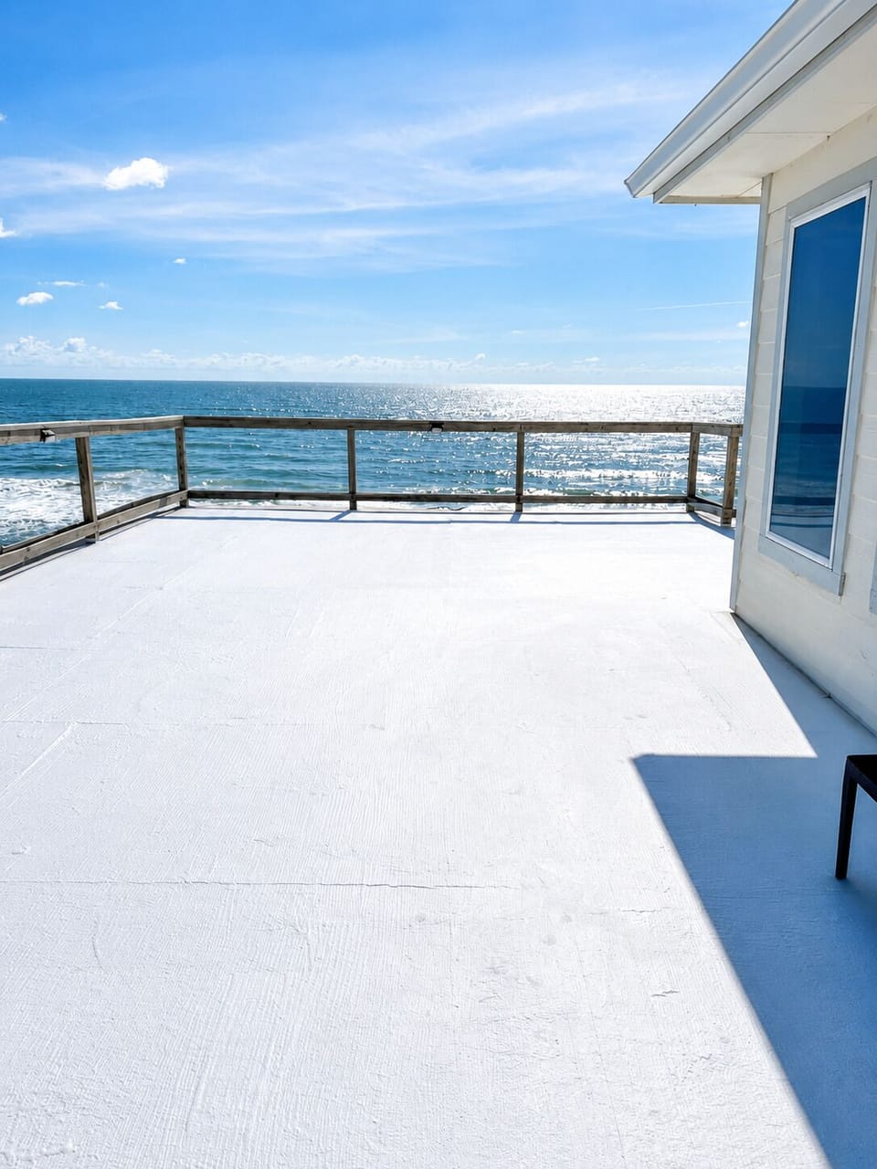 Spacious oceanfront deck with sweeping beach views—the perfect spot for morning 
