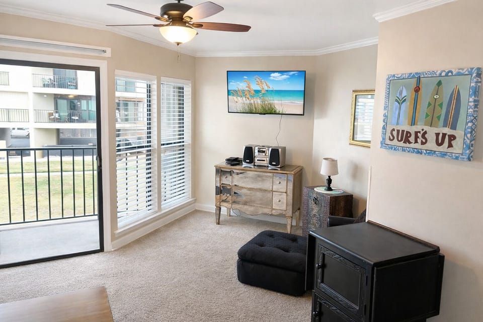 Living room with private balcony. Games in top drawer of dresser.