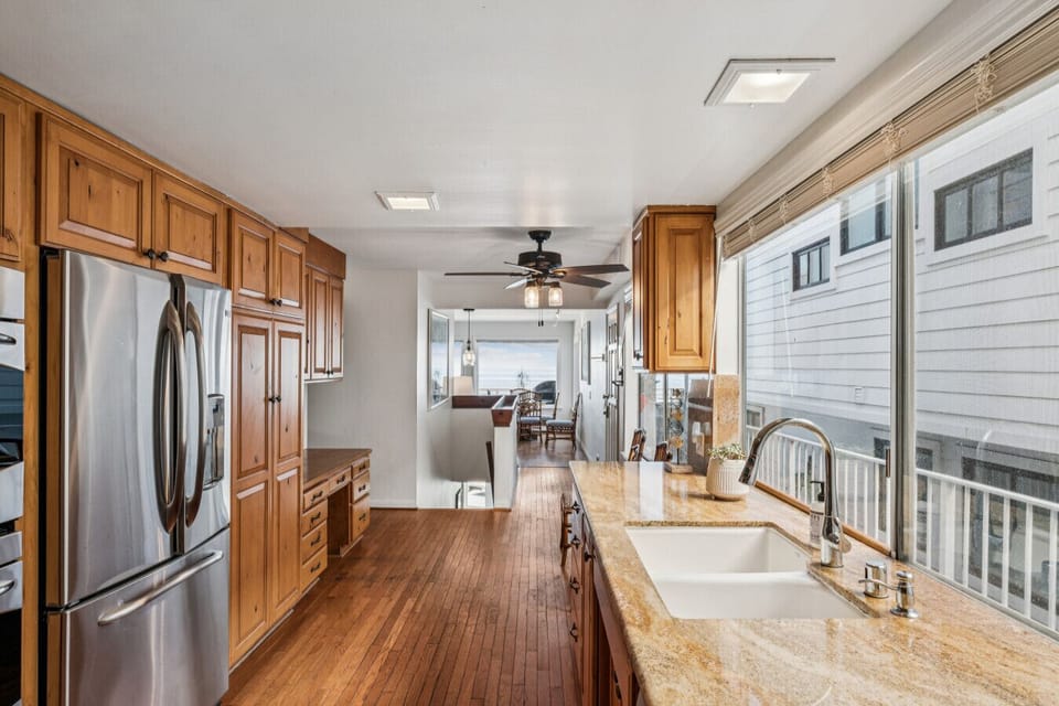 Fully equipped kitchen with stainless steel appliances and ample counter space.