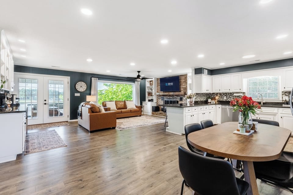 We LOVE the open floor plan that allows everyone to feel connected whether they're lounging in the living room, eating around the dining table, or cooking in the kitchen
