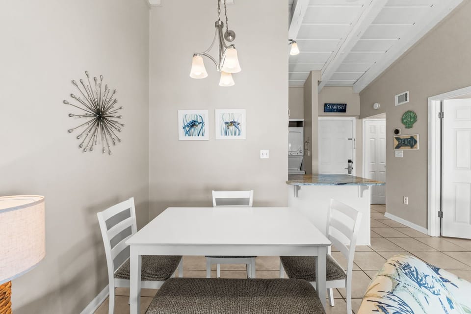 Dining area provide table with 3 chairs and bench seat.
