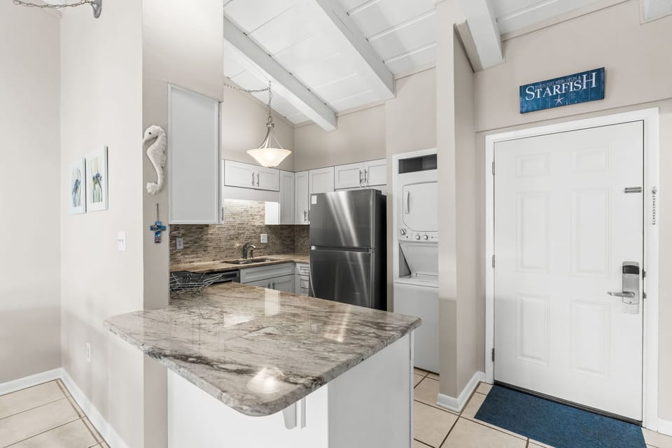 Nicely layed out kitchen that provides all the necessary items for a gourmet meal or a quik and go cup of coffee and pastry. Washer and dryer combo provided with a small bottle of detergent.