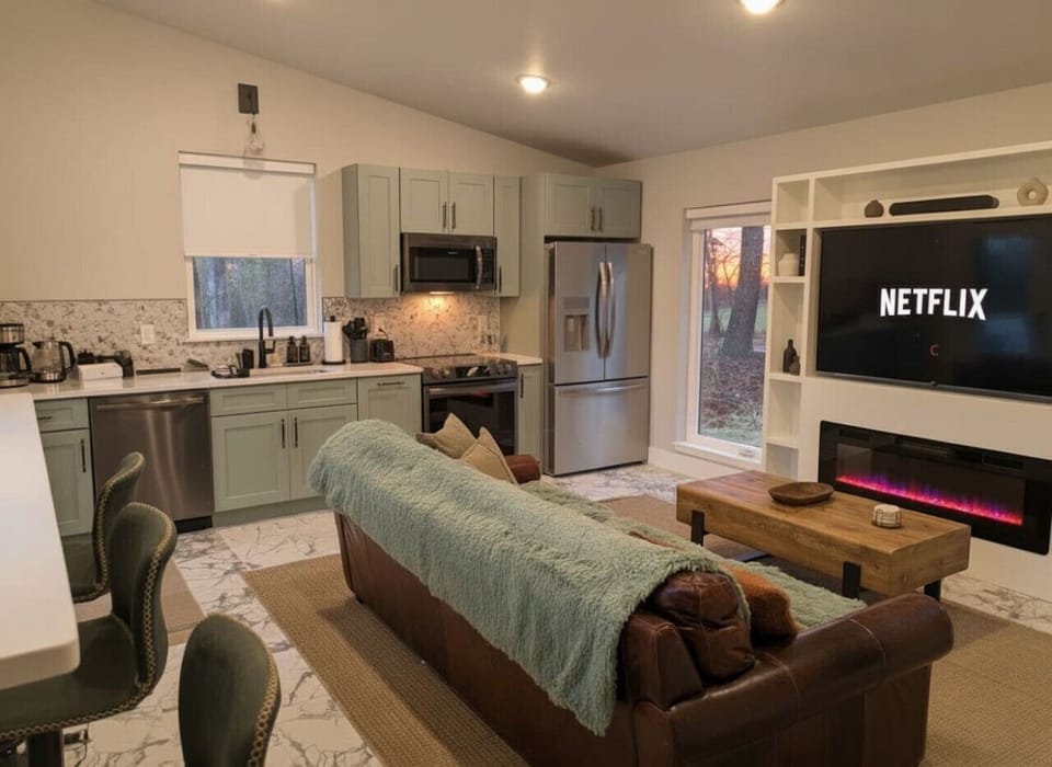 Loft-Style Open Living & Kitchen – Soaring ceilings and open flow connect the comfy living space to the sleek kitchen – relax, cook, and enjoy the wooded panorama all in one breathtaking area.