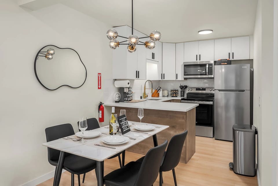 Modern kitchen with stainless steel appliances, perfect for cooking and enjoying wine.