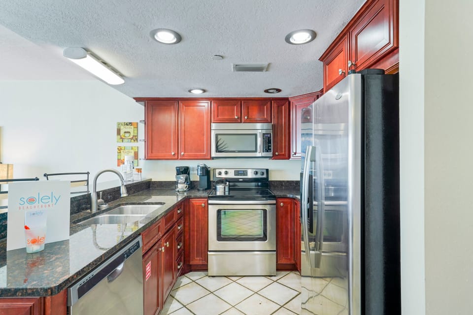 Cabana Club 307 boasts a beautifully updated kitchen with stainless steel appliances, ample counter space, and seating for family gatherings.