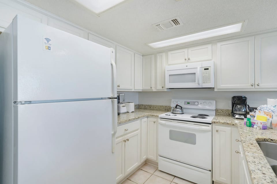 Start your day with breakfast in a kitchen designed for comfort and convenience during your Emerald Coast getaway.