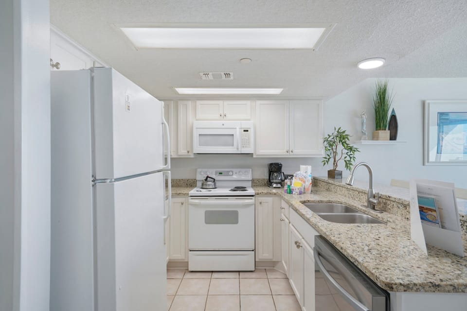 Prepare meals with ease in this bright coastal kitchen with modern appliances and ample counter space.