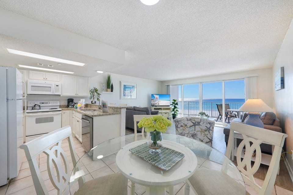 Gather for meals at the dining table just steps from the kitchen in this inviting Cabana Club vacation rental.