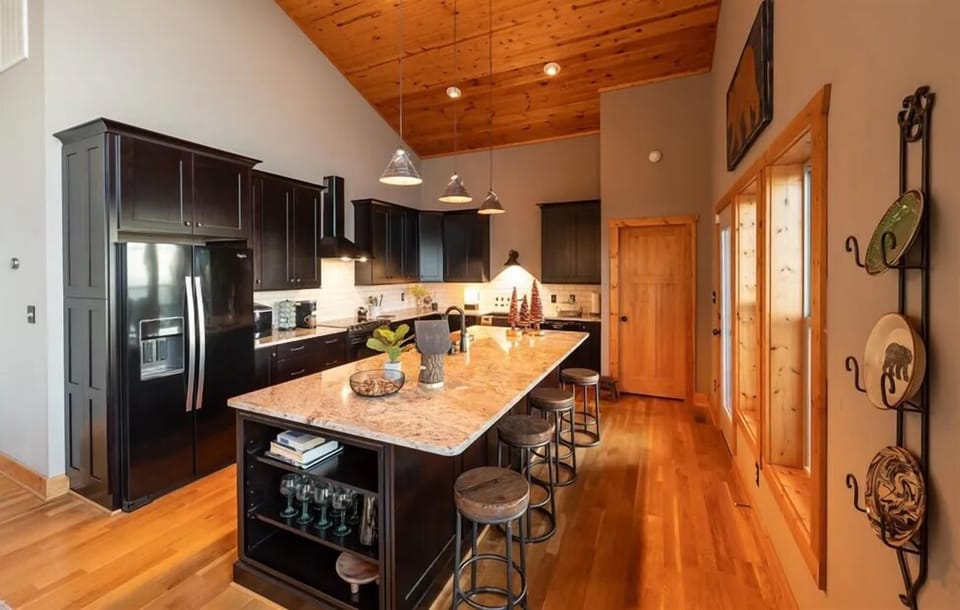 Chef's kitchen featuring granite countertops, a spacious island with bar seating, and all the essential prep tools you'll need. Crock Pot, Counter top Ice Maker, Toaster, K-Cup Maker, Tea Kettle, 12 Cup Coffee Maker, Margarita Blended Drink Maker