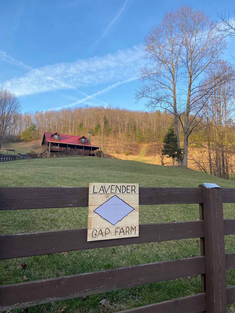 Driveway is to the left of sign.  