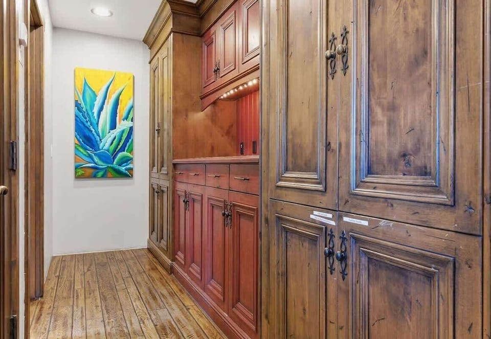 Unit 1: Hallway that leads to the kitchen and bathroom areas.