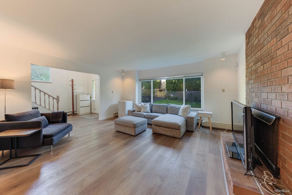 Spacious, living room with comfy seating, big-screen TV mini & fridge.