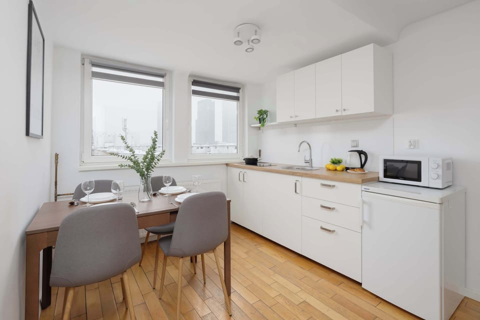Modern kitchen with dining space and natural light.