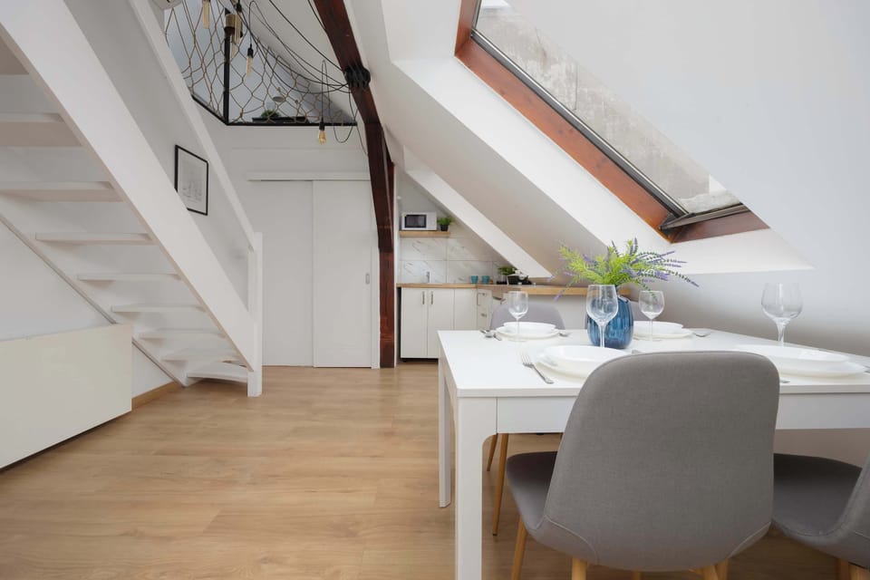 Dining area with table and stairs to the upper level.