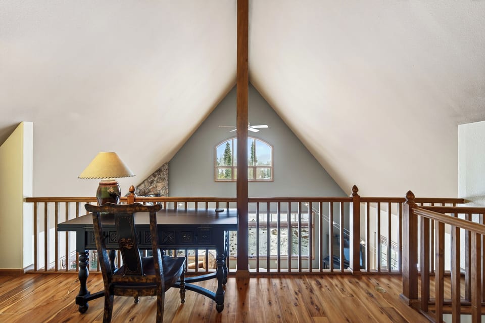 Loft area with a laptop-friendly table for a WFH setup.