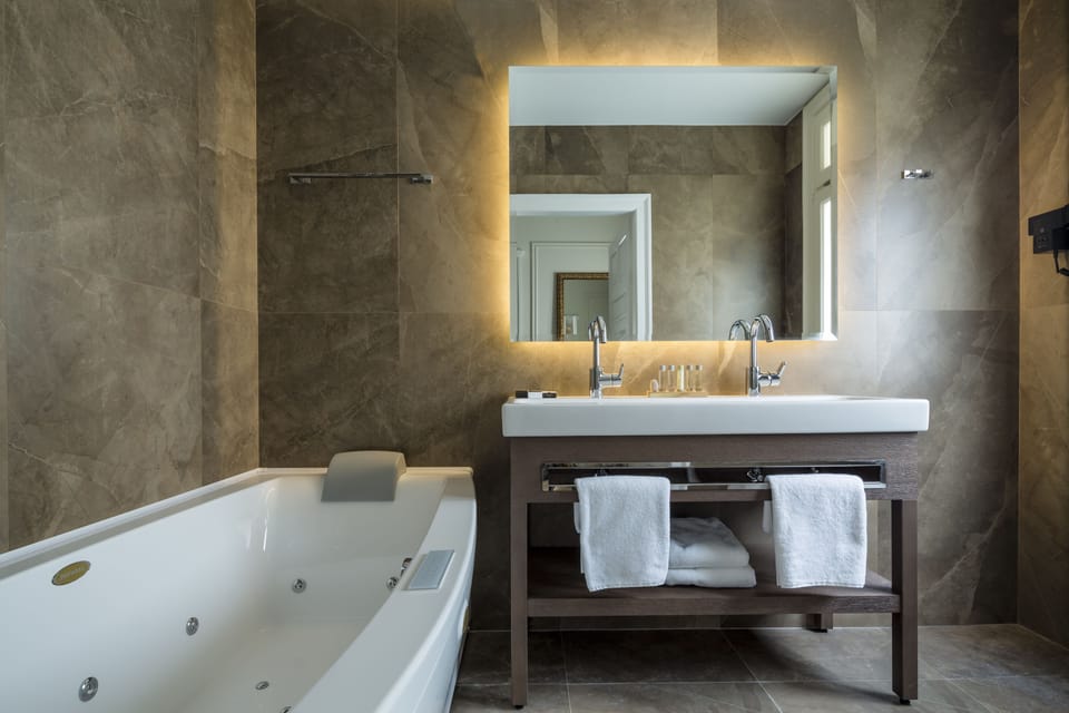Jetted tub, hydromassage showerhead, designer toiletries, hair dryer