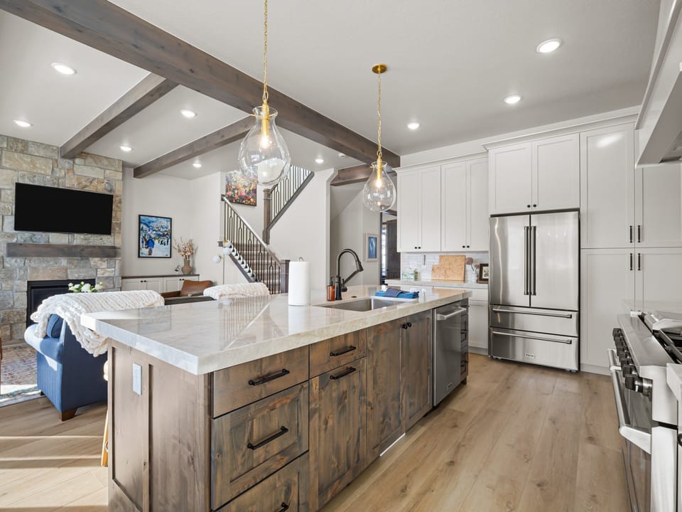 The chefs kitchen is well appointed with high end professional appliances, beautiful custom granite counter tops a built in dining table and bar seating for 5 and a large butlers pantry with wine fridge, extra preparation surface and numerous countertop appliances