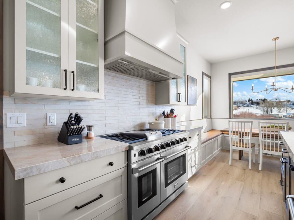 The chefs kitchen is well appointed with high end professional appliances, beautiful custom granite counter tops a built in dining table and bar seating for 5 and a large butlers pantry with wine fridge, extra preparation surface and numerous countertop appliances