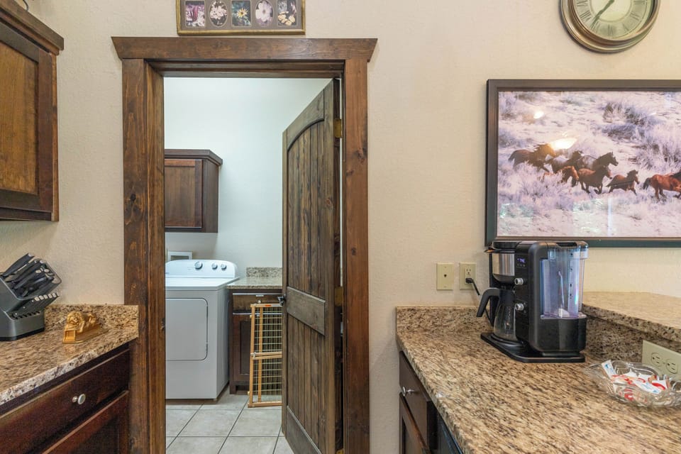 Kitchen and Laundry Room - View from the kitchen looking into the laundry room on the main floor. Kitchen is equipped with a standard drip coffee pot.