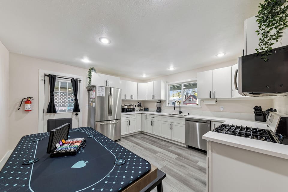 Whip up your favorite meals in this bright, fully-equipped kitchen featuring stainless steel appliances and ample counter space for cooking.