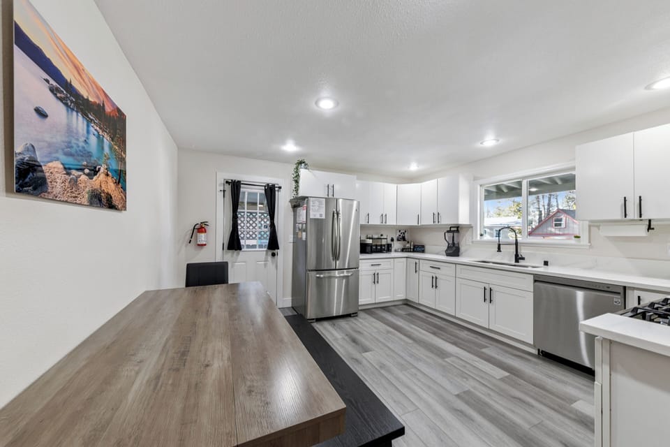 Your fully equipped kitchen features sleek white cabinets, modern appliances, and spacious countertops perfect for preparing your favorite meals during your stay.