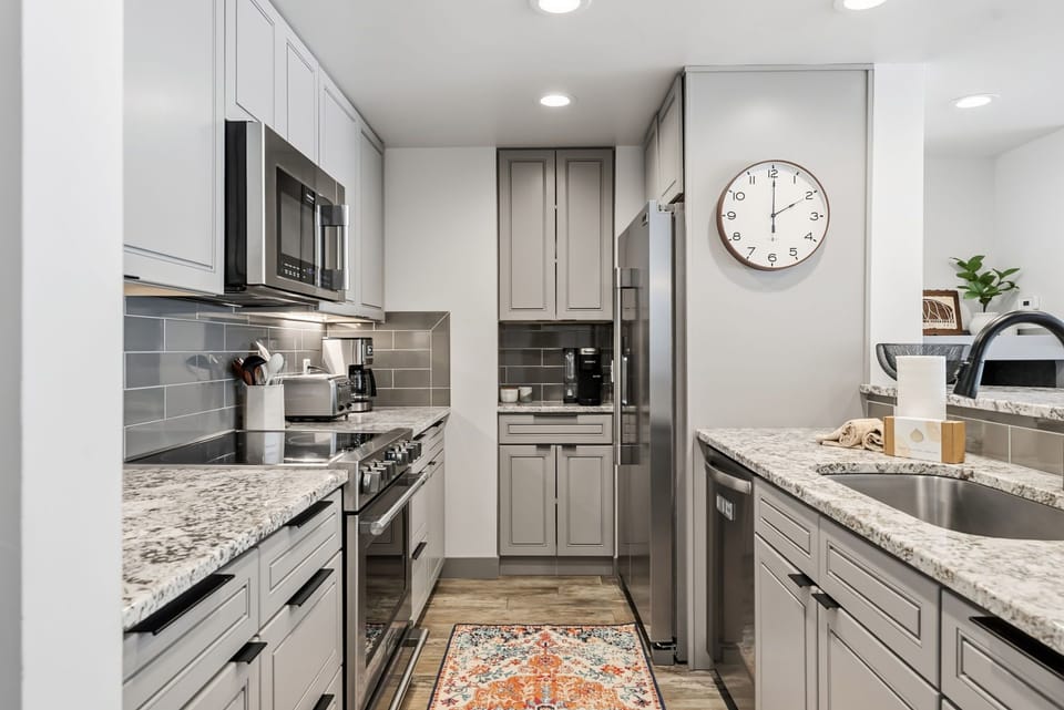 Your modern kitchen awaits with granite countertops, stainless appliances, and everything needed to create memorable meals during your stay.
