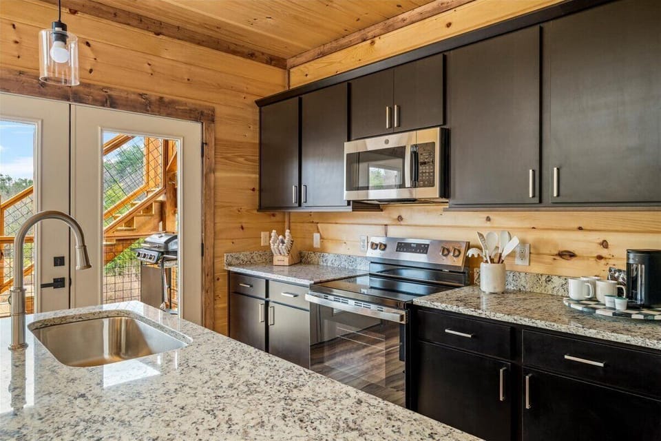 Your fully equipped kitchen blends modern convenience with rustic charm, featuring granite counters and everything you need to create memorable meals.