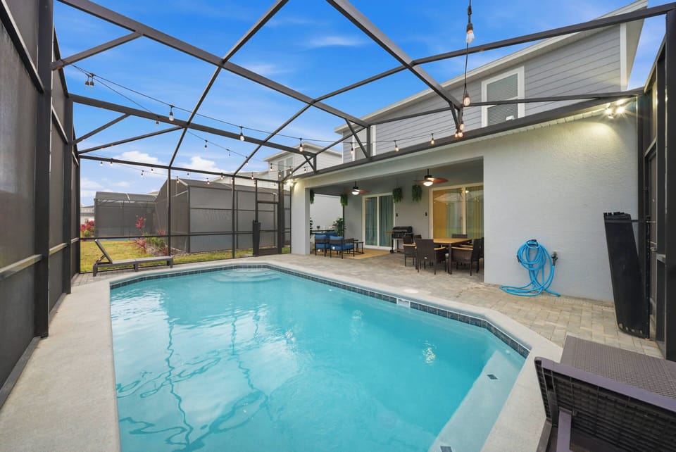 Discover your private oasis in this inviting pool area, enclosed for your comfort and protection. The crystal-clear water sparkles in the afternoon light, and nearby seating beckons you to sit back and relax.