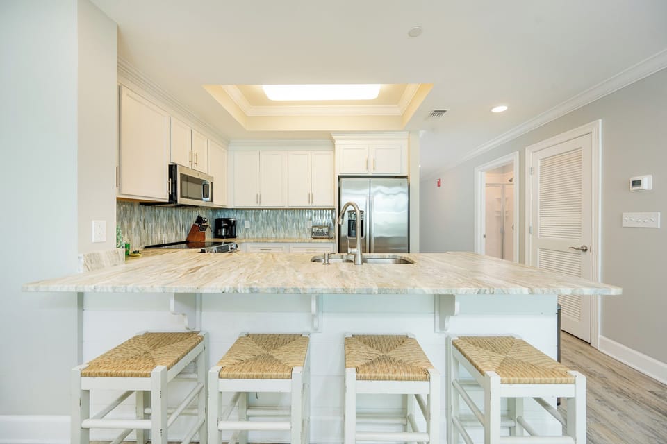 Sip your morning coffee at the breakfast bar and get ready for a beach day in this stylish space