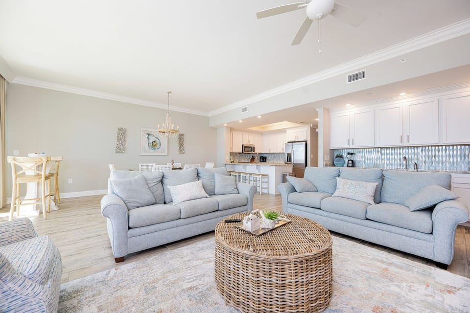 Gather in this welcoming living space and enjoy stunning panoramic beach views through the windows