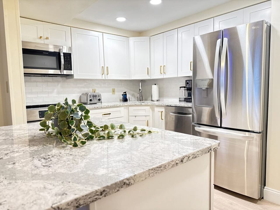 Sleek, fully-equipped kitchen and granite island.