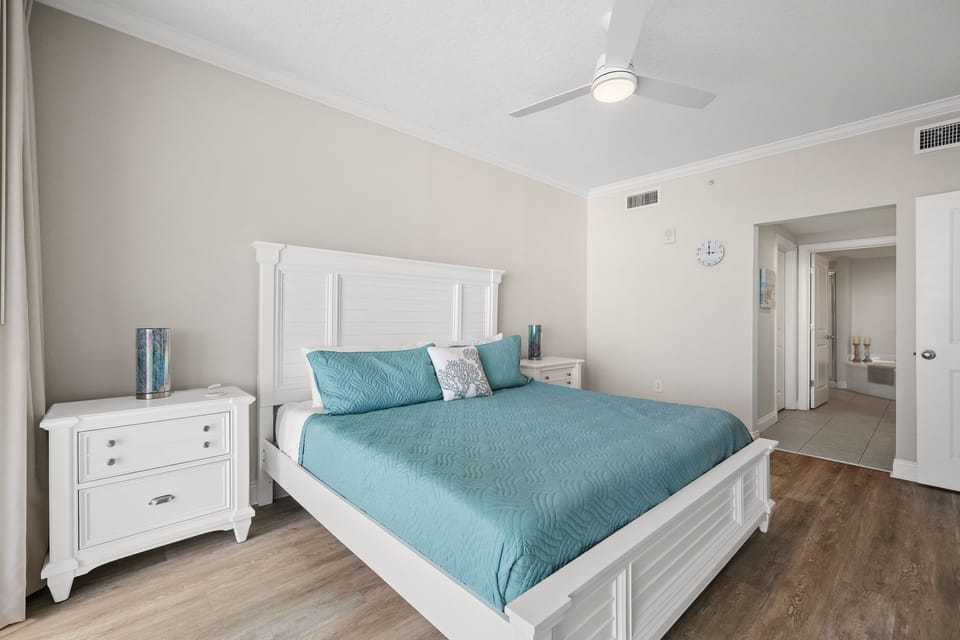 Sleep soundly in your coastal-inspired bedroom with crisp white furniture and soothing turquoise bedding that feels like ocean waves.