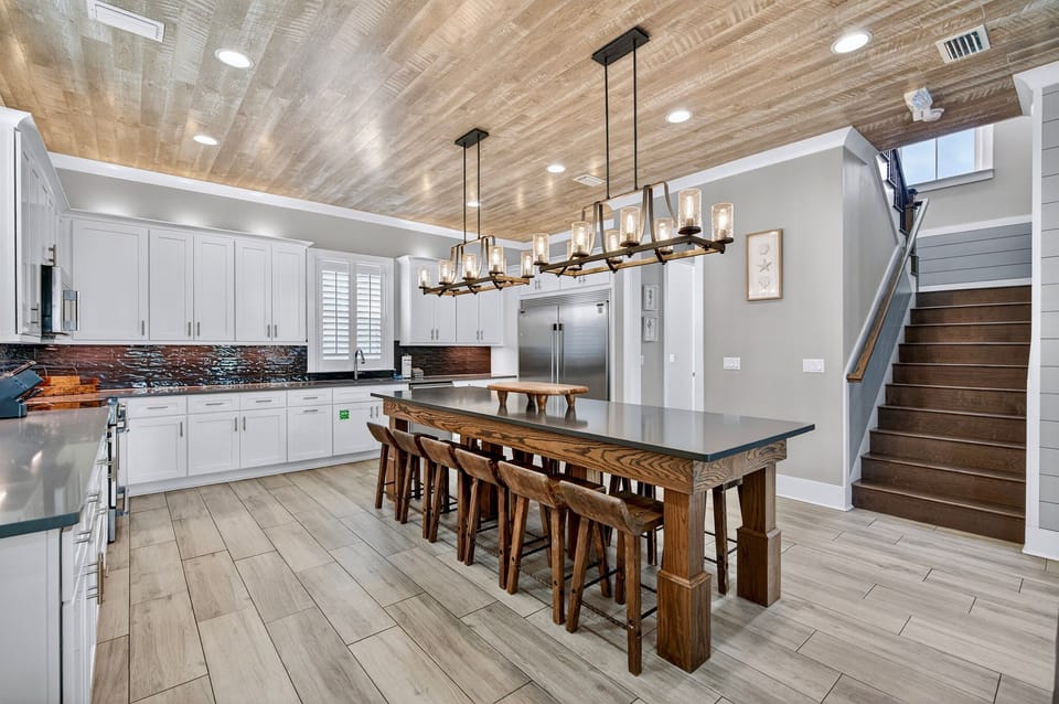 1st Floor Kitchen & Dining — Open-concept chef’s kitchen with modern appliances and generous counter space, paired with a spacious dining area offering seating for 12 guests, ideal for family meals, celebrations, and effortless group entertaining.