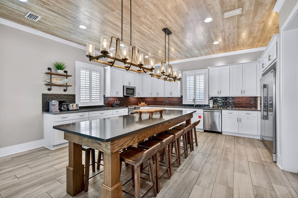 1st Floor Kitchen & Dining — Open-concept chef’s kitchen with modern appliances and generous counter space, paired with a spacious dining area offering seating for 12 guests, ideal for family meals, celebrations, and effortless group entertaining.