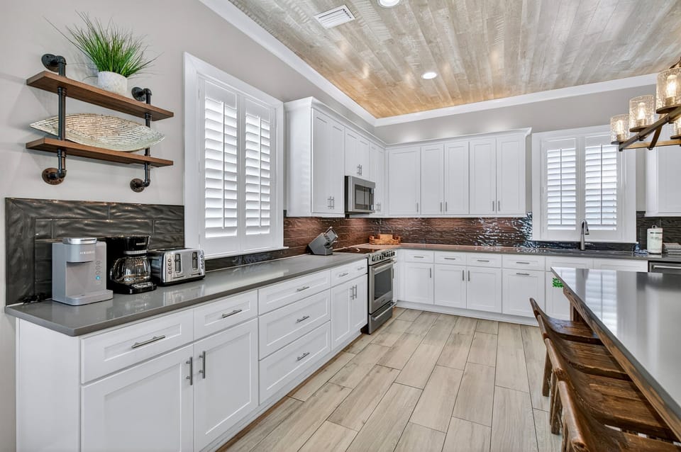 1st Floor Kitchen & Dining — Open-concept chef’s kitchen with modern appliances and generous counter space, paired with a spacious dining area offering seating for 12 guests, ideal for family meals, celebrations, and effortless group entertaining.