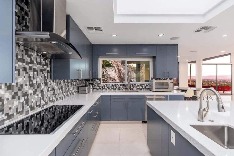 A sleek, modern kitchen awaits your culinary adventures, with high-end appliances, ample counter space, and stunning views framing your cooking experience perfectly.