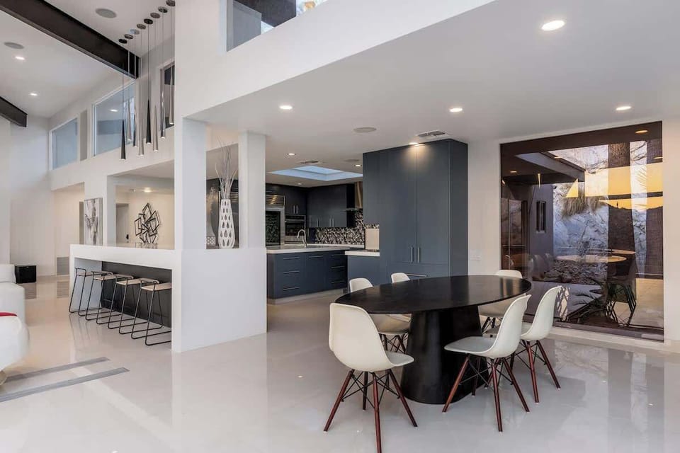 Step into this stunning open-concept space where sleek modern design meets comfort. Gather at the chic dining table, unwind at the breakfast bar, or prepare meals in your stylish kitchen—all bathed in natural light from soaring ceilings.