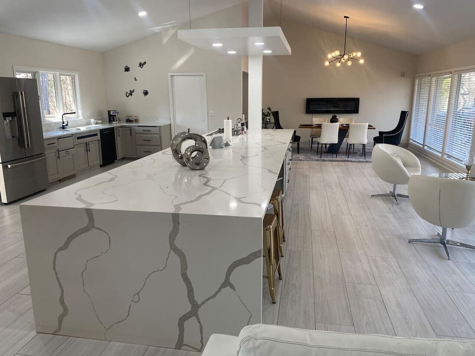 Stunning marble waterfall kitchen island as the centerpiece
