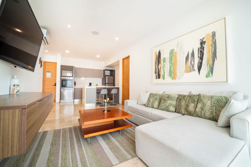 Deluxe Condo | Living area | 50-inch TV with digital channels