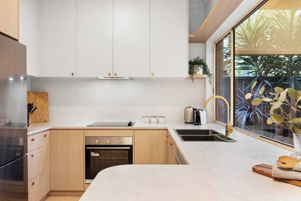 Cook with ease in the modern kitchen, where generous bench space, quality appliances, and garden outlooks make everyday meals feel relaxed.