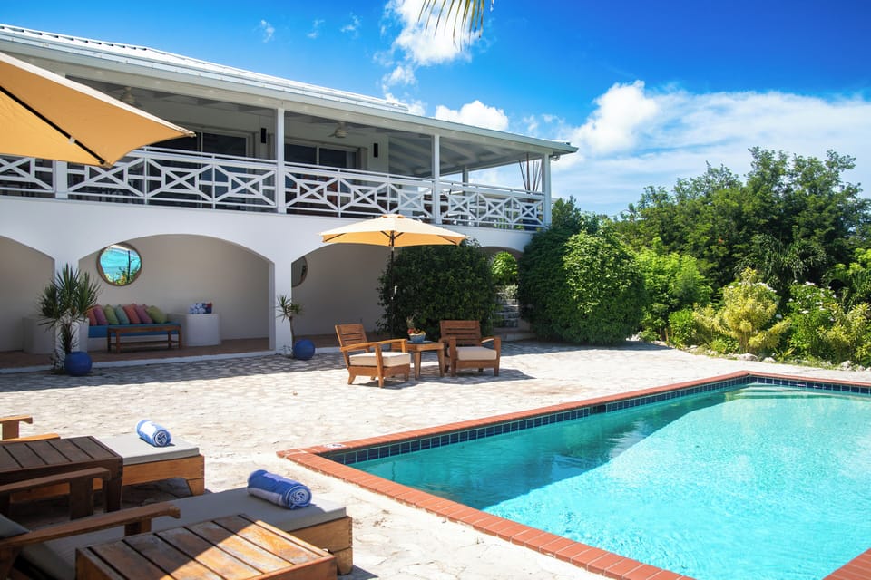 Outdoor pool area with covered bar and lounge area