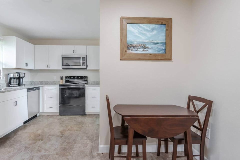 View from the front door of the full kitchen and dining table with seating for two