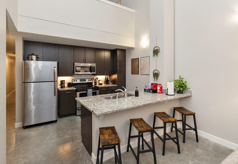 Kitchen area w/ all appliances, cookware, breakfast bar with stools & free coffee bar
